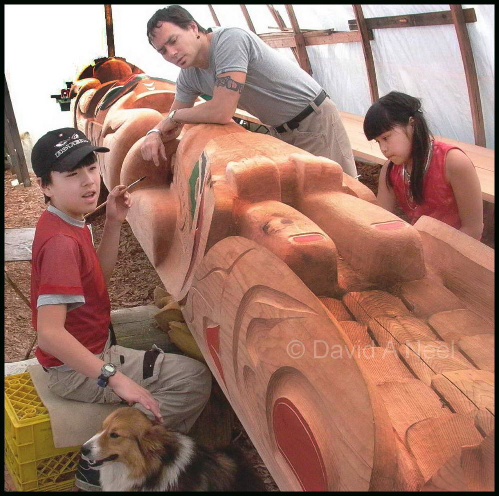 David's children, Edwin and Ellena learning the paint a totem pole.